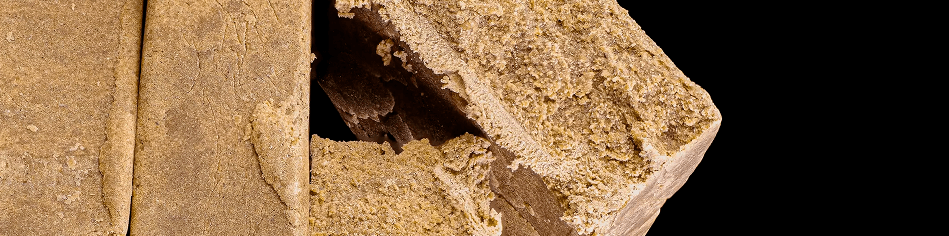 Light brown dry sift hash blocks with a sandy, crumbly texture.