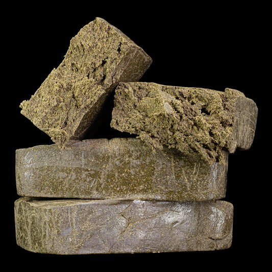 Stack of hash bricks with a dark background manali cream thca